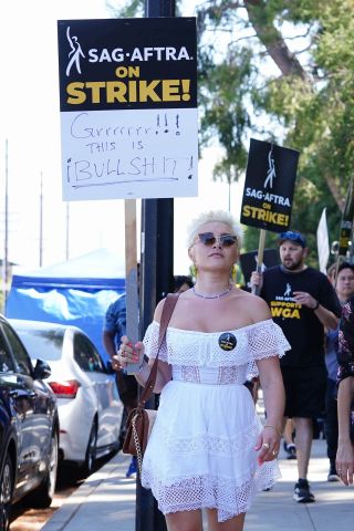 Florence Pugh (L) walks the picket line in support of the SAG-AFTRA and WGA strike at Disney Studios on August 15, 2023 in Burbank, California.