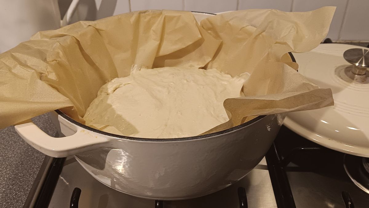 Enamelled cast iron own with bread ready to bake