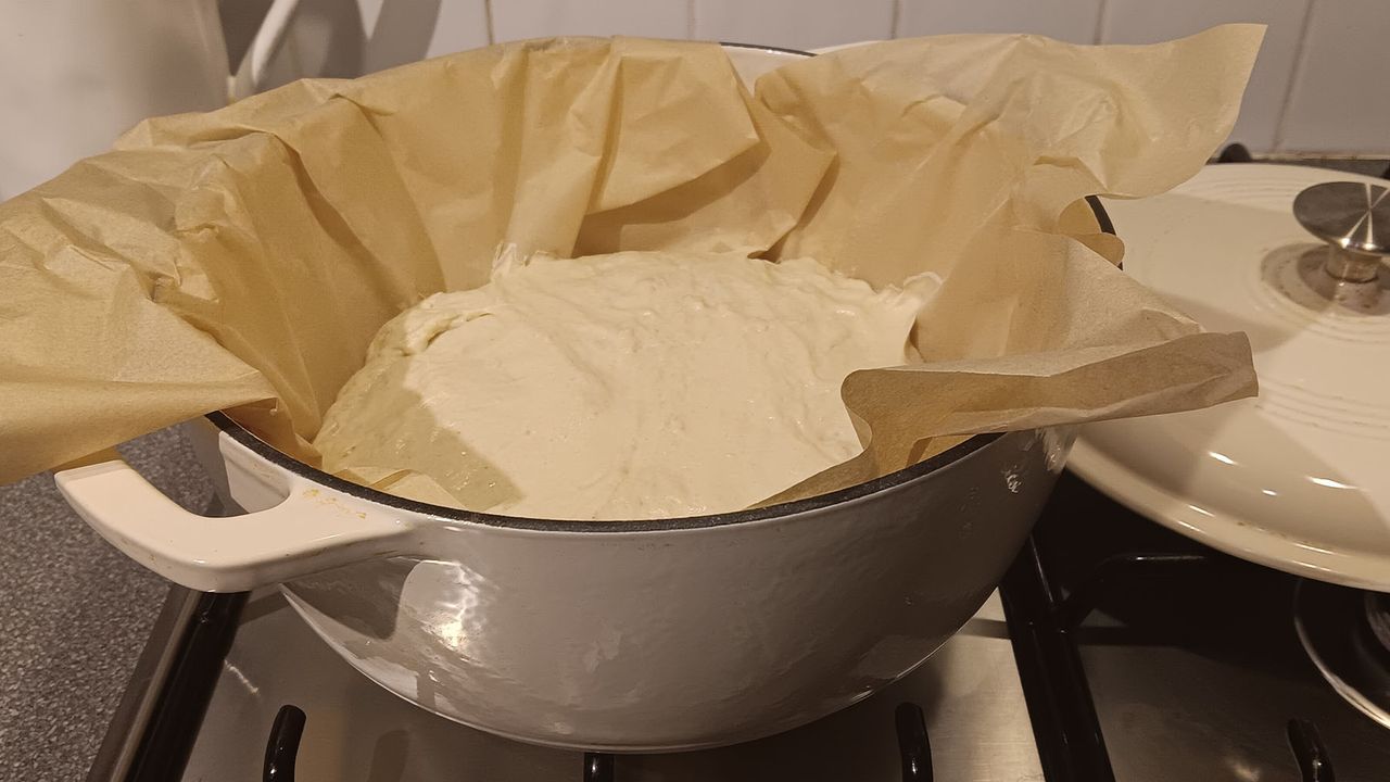 Enamelled cast iron own with bread ready to bake