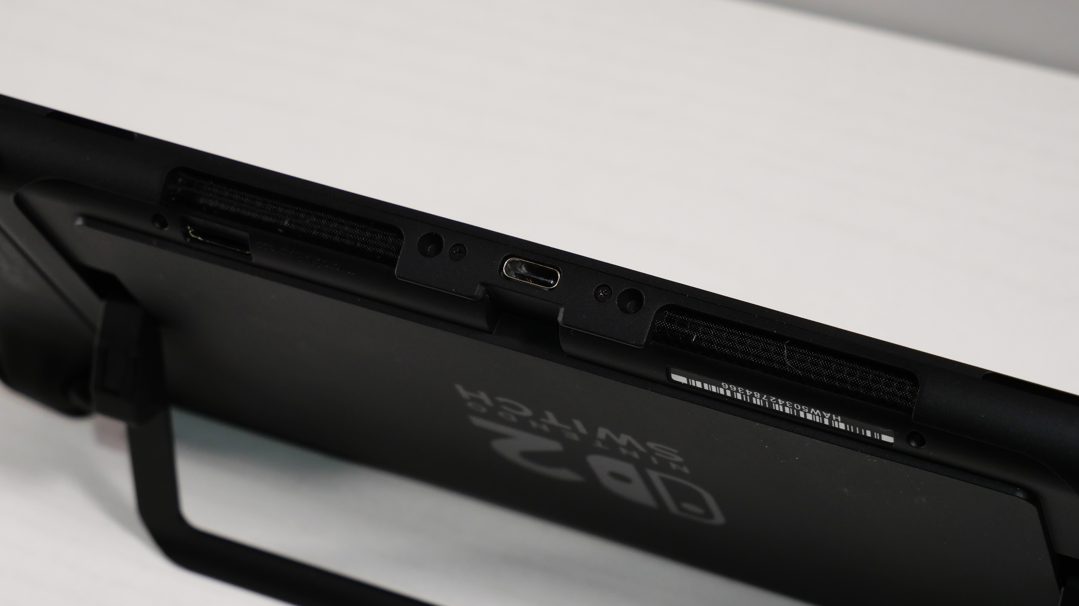 Nintendo Switch 2 on a white desk, highlighting its ports on the bottom.