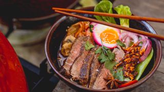 Beef noodles with beetroot-stained egg