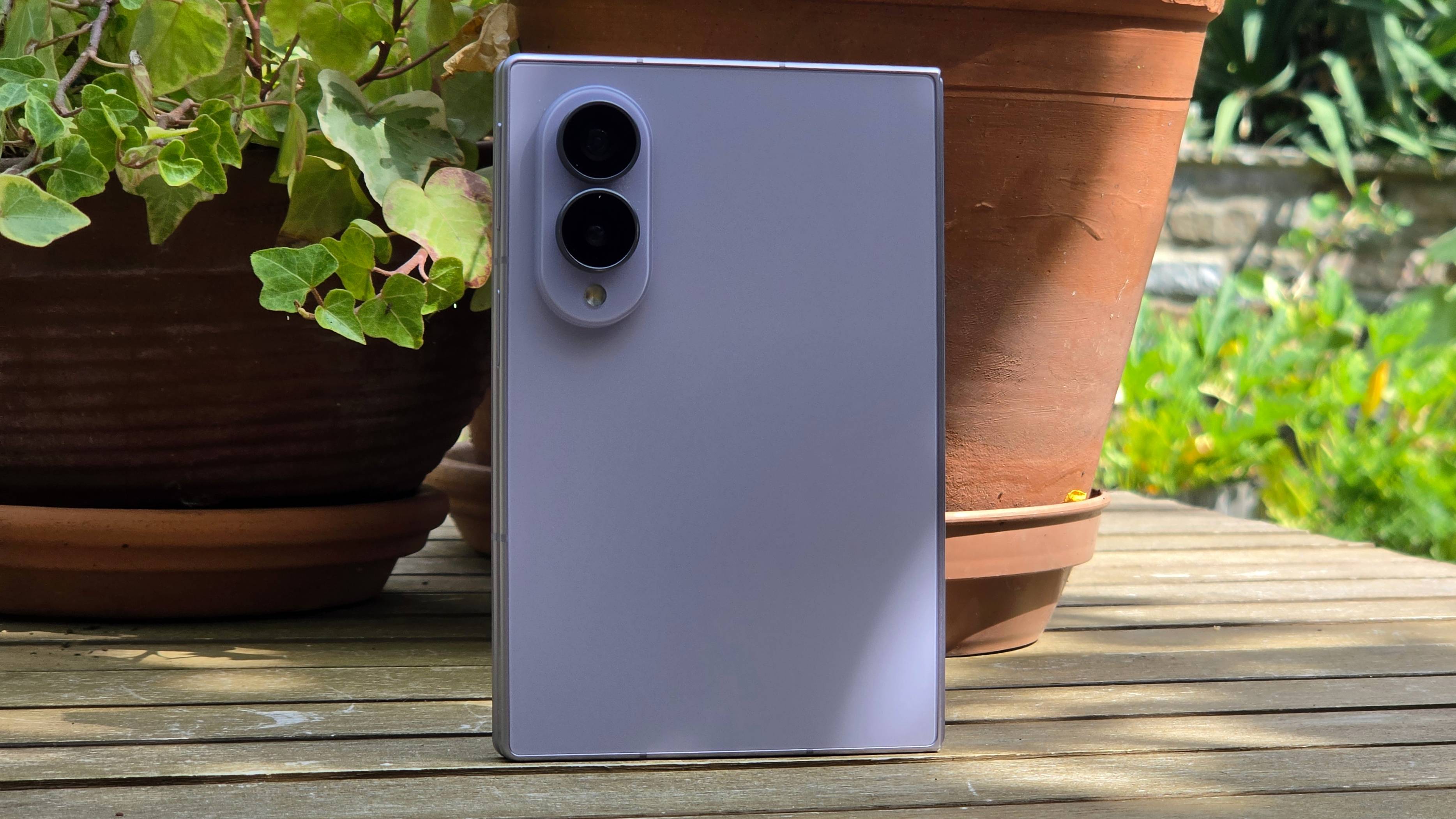 The Samsung Galaxy Z Fold 8 on a wooden table, stood upright.
