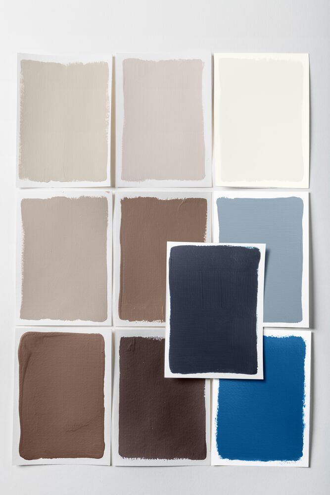 Image of nine paint swatches that make up a neutral and brown palette that supports a navy blue paint color as the base.