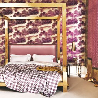 Bright purple bedroom with palm tree wallpaper, purple and white linen and gold bed frame