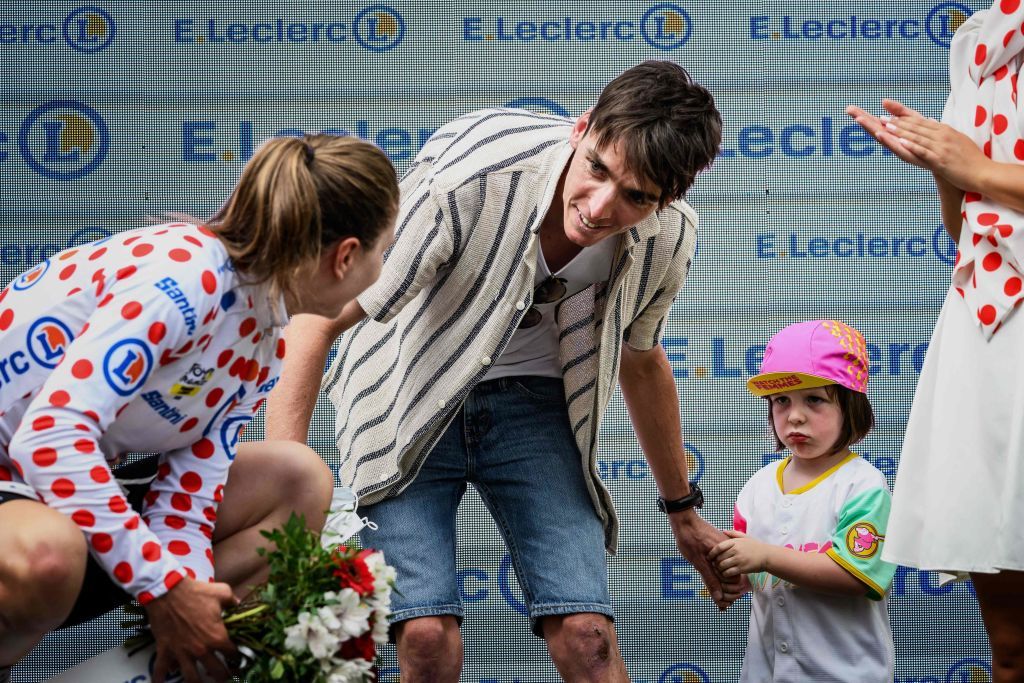 French rider Romain Bardet C and his son R talk with Team SD Worxs Belgian rider Lotte Kopecky L after she receives the Polka Jersey on the podium of the first stage out of 8 of the second edition of the Womens Tour de France cycling race 124 km around ClermontFerrand in the PuydeDome department of central France on July 23 2023 Photo by JEFF PACHOUD AFP Photo by JEFF PACHOUDAFP via Getty Images
