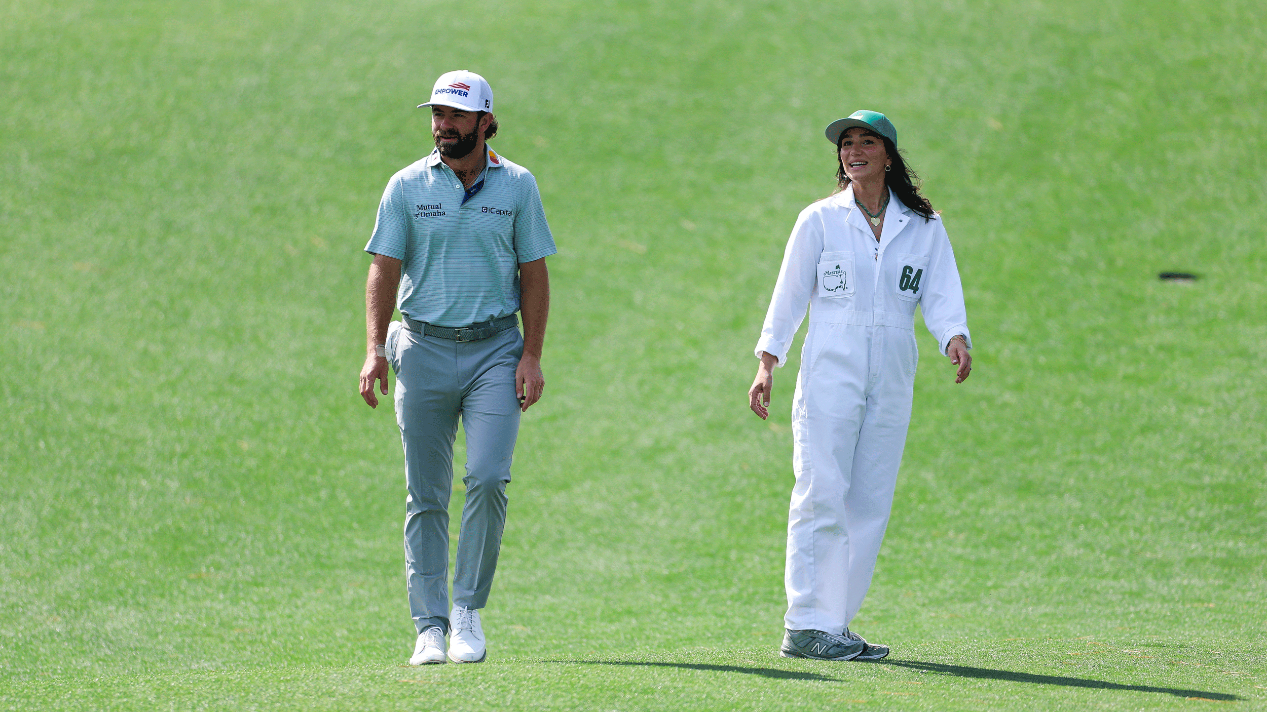 Cameron Young and his wife Kelsey walk along during The Masters Par 3 contest in 2026