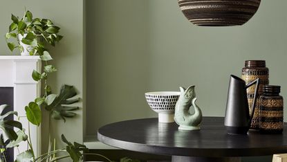 A muted green color painted on a living room wall
