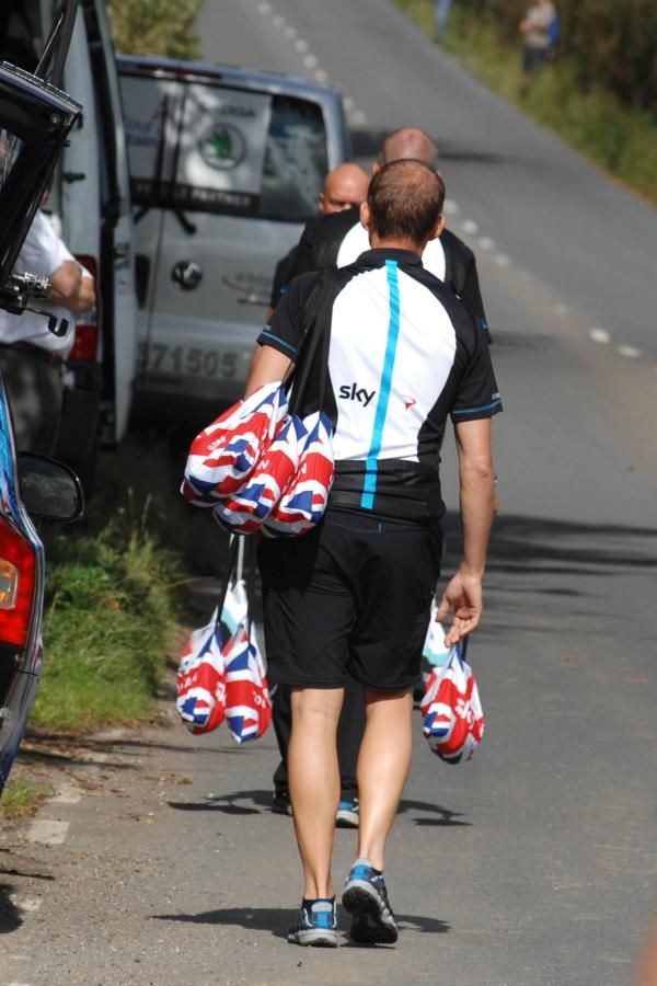 Sky staff wait to hand off food at the feed zone