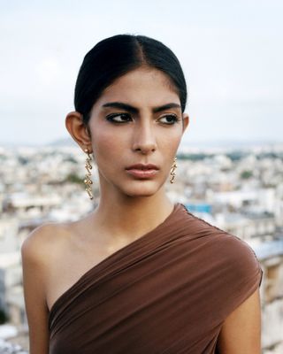woman wears Byredo Fine jewellery earrings