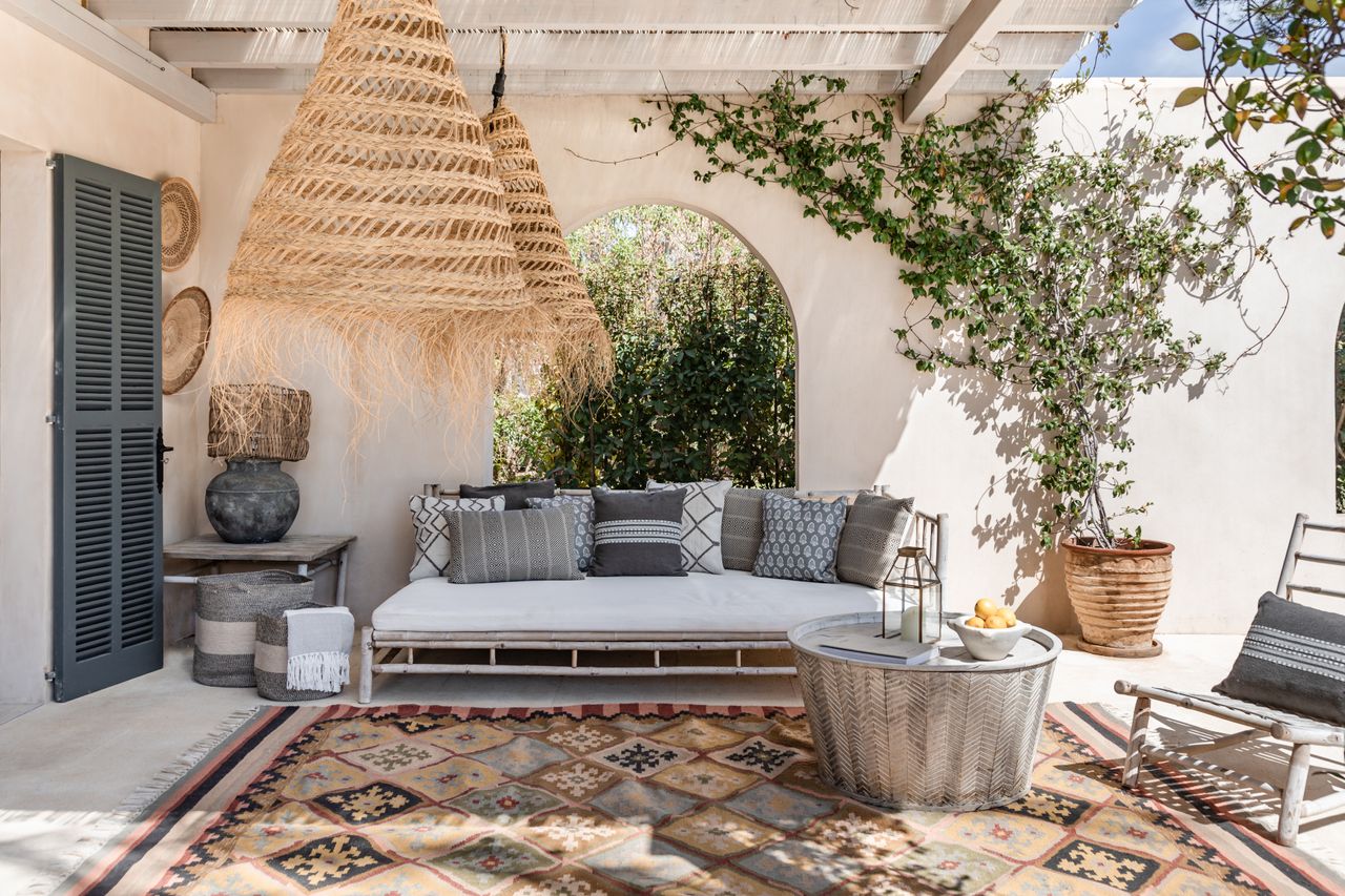 A sunsoaked garden nap area for outdoor sleeping, featuring a Nomad Xanthos Rug by Weaver Green