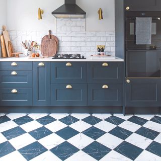 Navy shaker kitchen with black and white checkerboard flooring