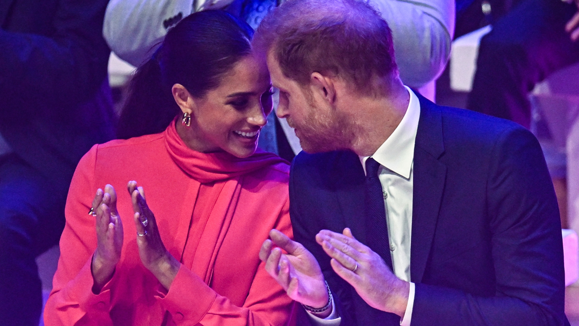 Britain's Meghan, Duchess of Sussex (L) and Britain's Prince Harry, Duke of Sussex, speak together as they applaud while attending the annual One Young World Summit at Bridgewater Hall in Manchester, north-west England on September 5, 2022. - The One Young World Summit is a global forum for young leaders, bringing together young people from over 190 countries around the world to come together to confront the biggest challenges facing humanity.