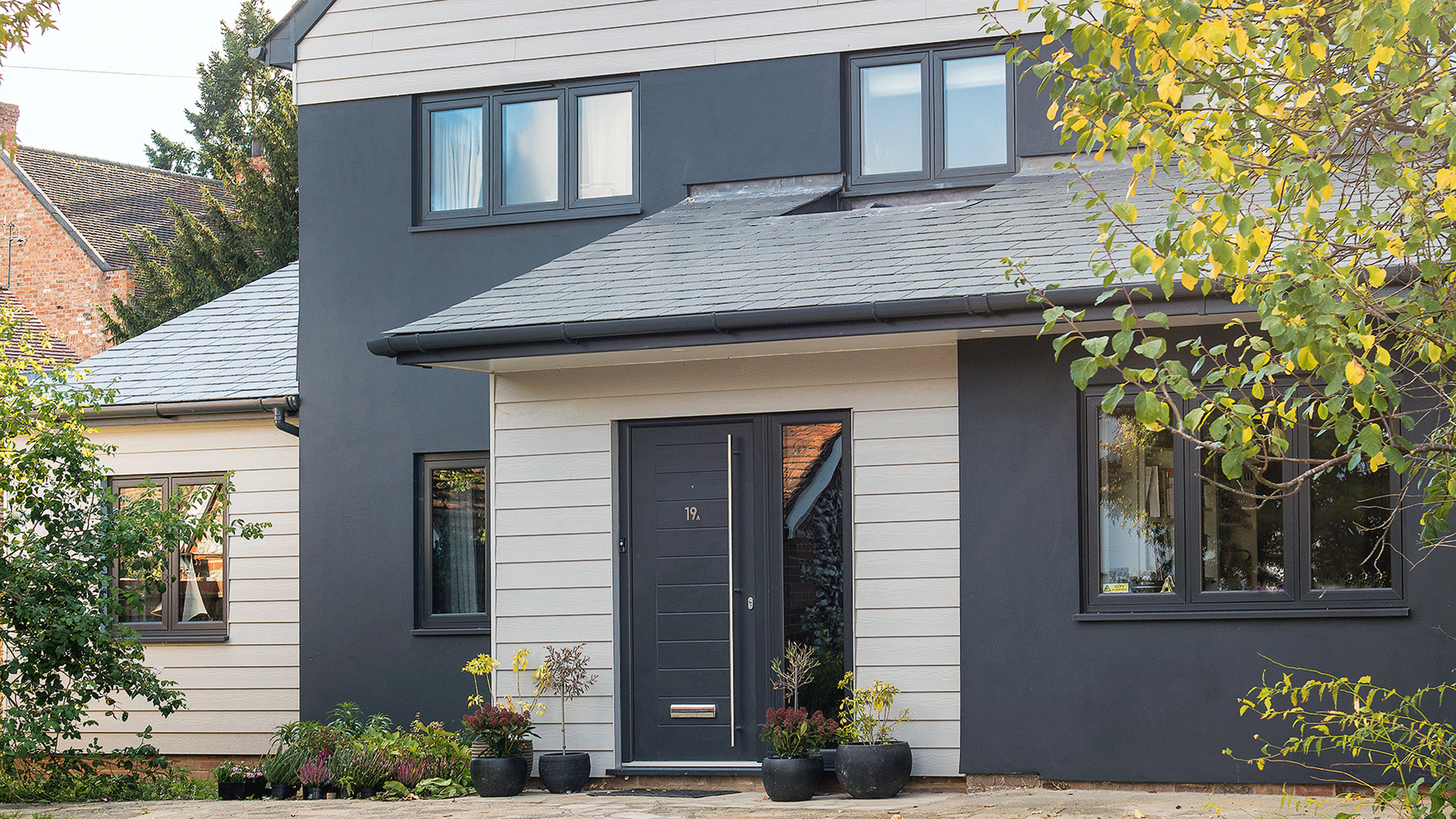 Victorian semi with kitchen extension tiled in pale blue with timber cladding