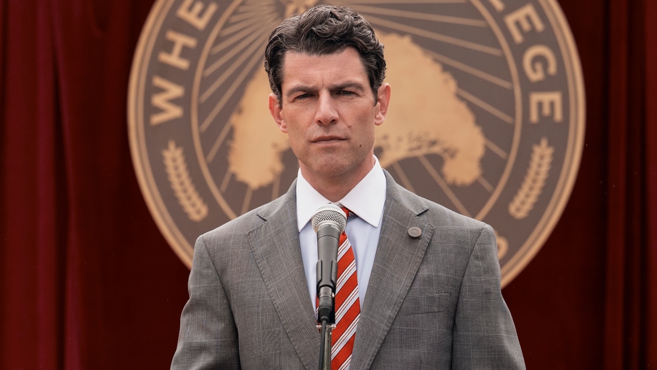 Max Greenfield in front of Wheeler College sign in A Man on the Inside Season 2