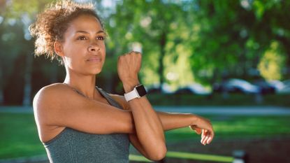 Woman stretches out the muscles in her arm