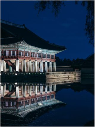 Palace reflected in water, at night