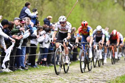 Tadej Pogacar leads the peloton onto the cobbles