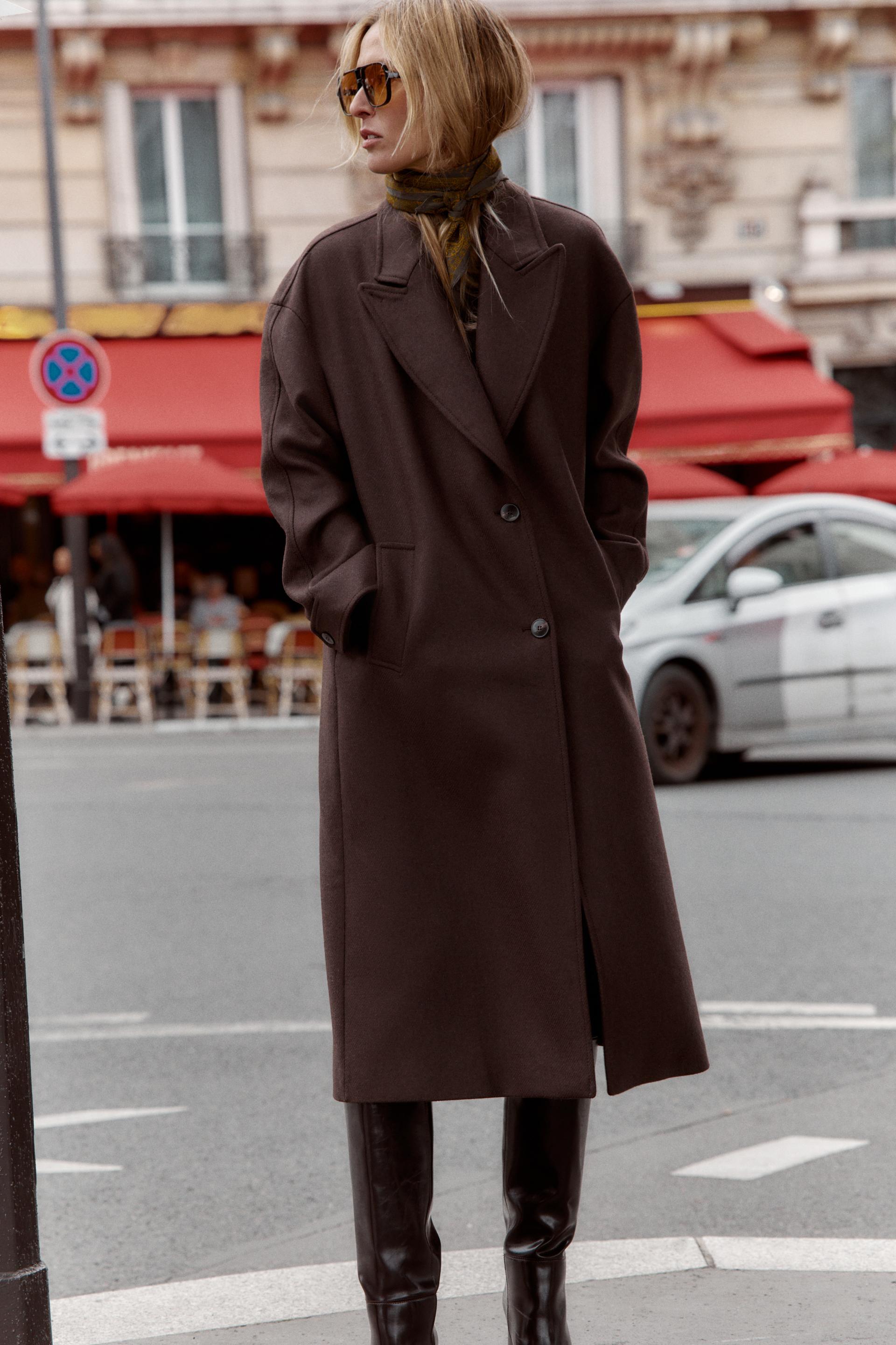 Zara winter coat trends. The model wears a chocolate brown coat.
