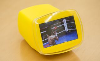 Boxer in a ring in front of spectators on a yellow screen