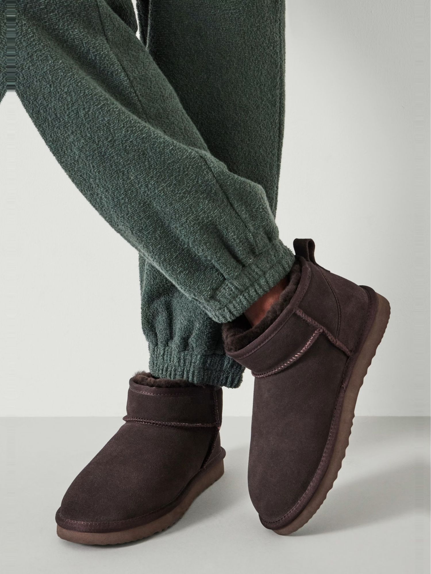 Ultra Mini Sheepskin Boots in Chocolate Brown on model