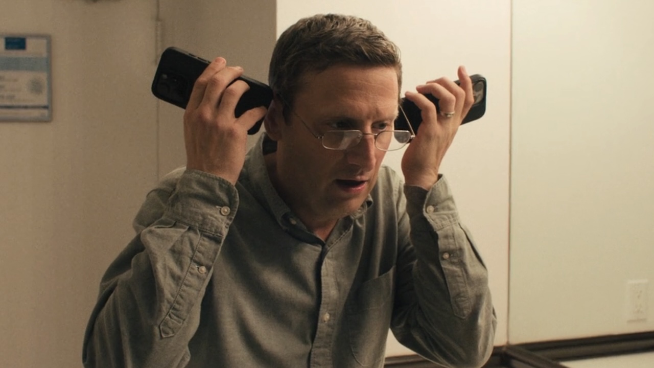 Ron listening to two phones at once in men&#039;s room in The Chair Company Season 1 finale