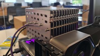 The Noctua NH-P1 air cooler mounted on an open-bed test bench with pink RGB lighting