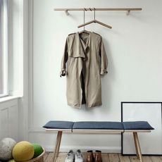 white wall room wooden wall hanger and coat on hanger