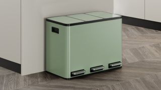 A modern mint-green kitchen recycling bin with three separate compartments, each with its own foot pedal, designed for easy waste sorting.