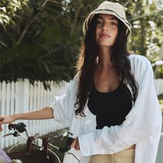 Models wear J.Crew. One model wears a white button-down top and a white skirt. One model wears a red utility shirt dress with a sweater around her waist. One girl wears a drop-waist smocked dress.