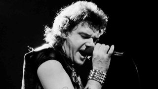 Paul Di’Anno performing onstage with Iron Maiden in 1980