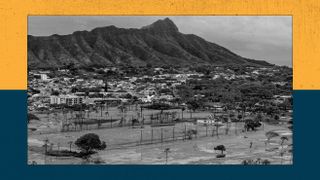 An inundated golf course in the foreground and a mountain in the background.