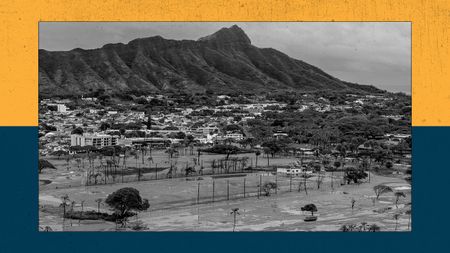 An inundated golf course in the foreground and a mountain in the background.