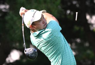 Lee Chieh-po strikes a tee shot with a driver