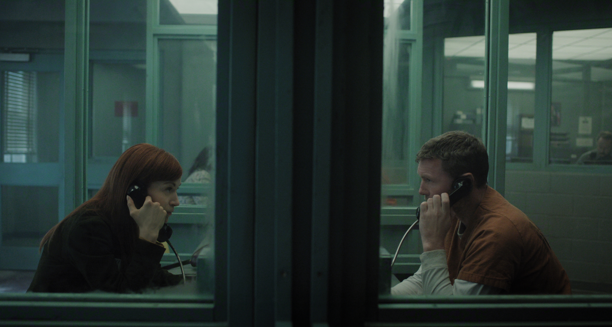 britt lower as rachel talking to sam worthington as david over the phone through a window in prison in a still from i will find you 