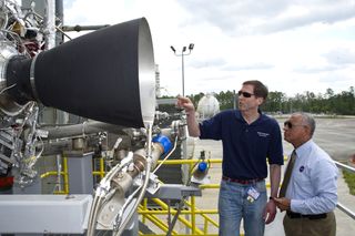 Steve Knowles, Blue Origin project manager (left) points out details of Blue Origin's BE-3 engine thrust chamber assembly to NASA Administrator Charles Bolden. The rocket gear is set for May testing on the E-1 Test Stand at NASA's Stennis Space Center in south Mississippi. The BE-3 will be used on Blue Origin's reusable launch vehicle as part of the agency's Commercial Crew Development Program. Blue Origin is one of NASA's partners developing innovative systems to reach low-Earth orbit.