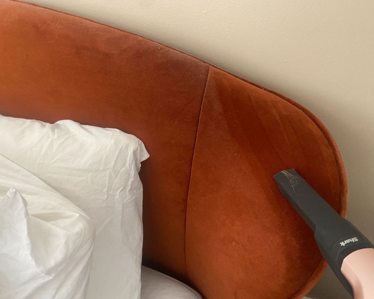 Shark Wandavac crevice tool on use on velvet bed