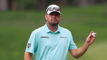 Robert Garrigus waves to the crowd 