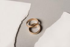 divorce concept with two rings on a torn piece of white paper