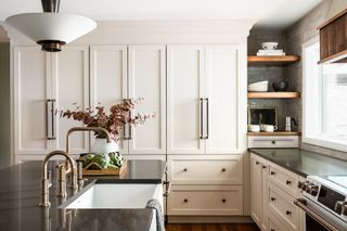 Natural light-filled kitchen with cabinets paintedi in Benjamin Moore's Creamy White.