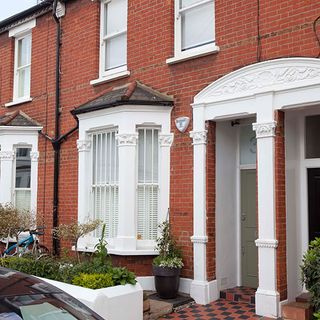 home with brick wall and white window