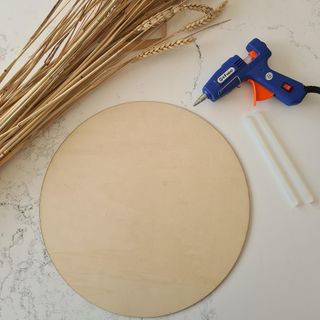 blue glue gun and wheat and wooden disc