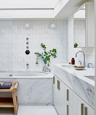 white bathroom with calacatta marble in Victorian mews house in London with contemporary interior designed by Kitesgrove