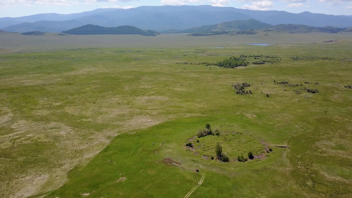 Here, an aerial view of the burial mound in southern Siberia. A distinct circle can be seen on one plane. 