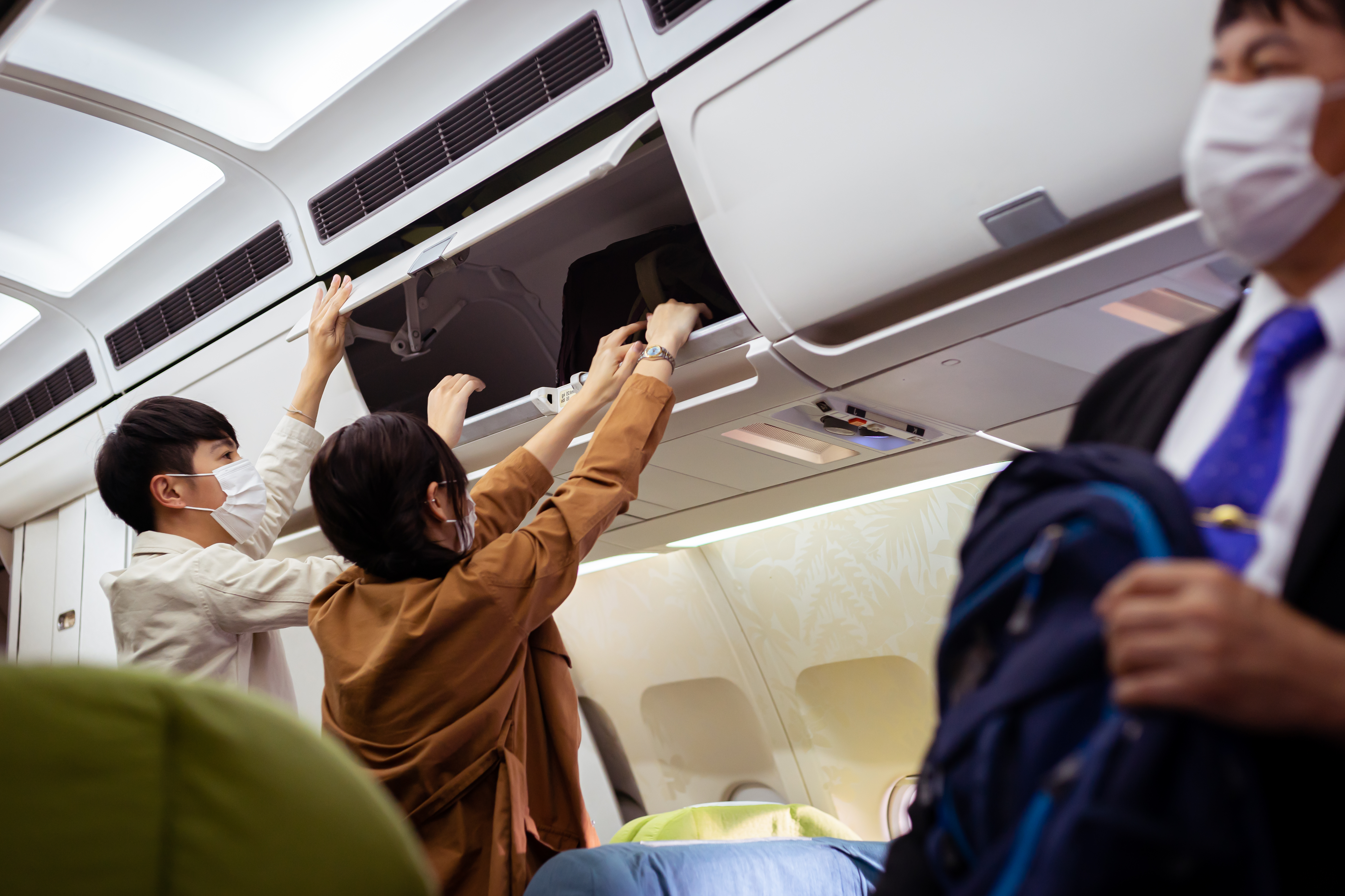 Young couple getting onto a plane, following the rollout of the Covid-19 vaccine passports