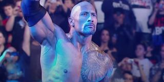 The Rock standing stoic in WWE ring