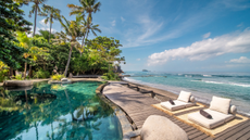 Outdoor pool and sun loungers at The Seed, Bali