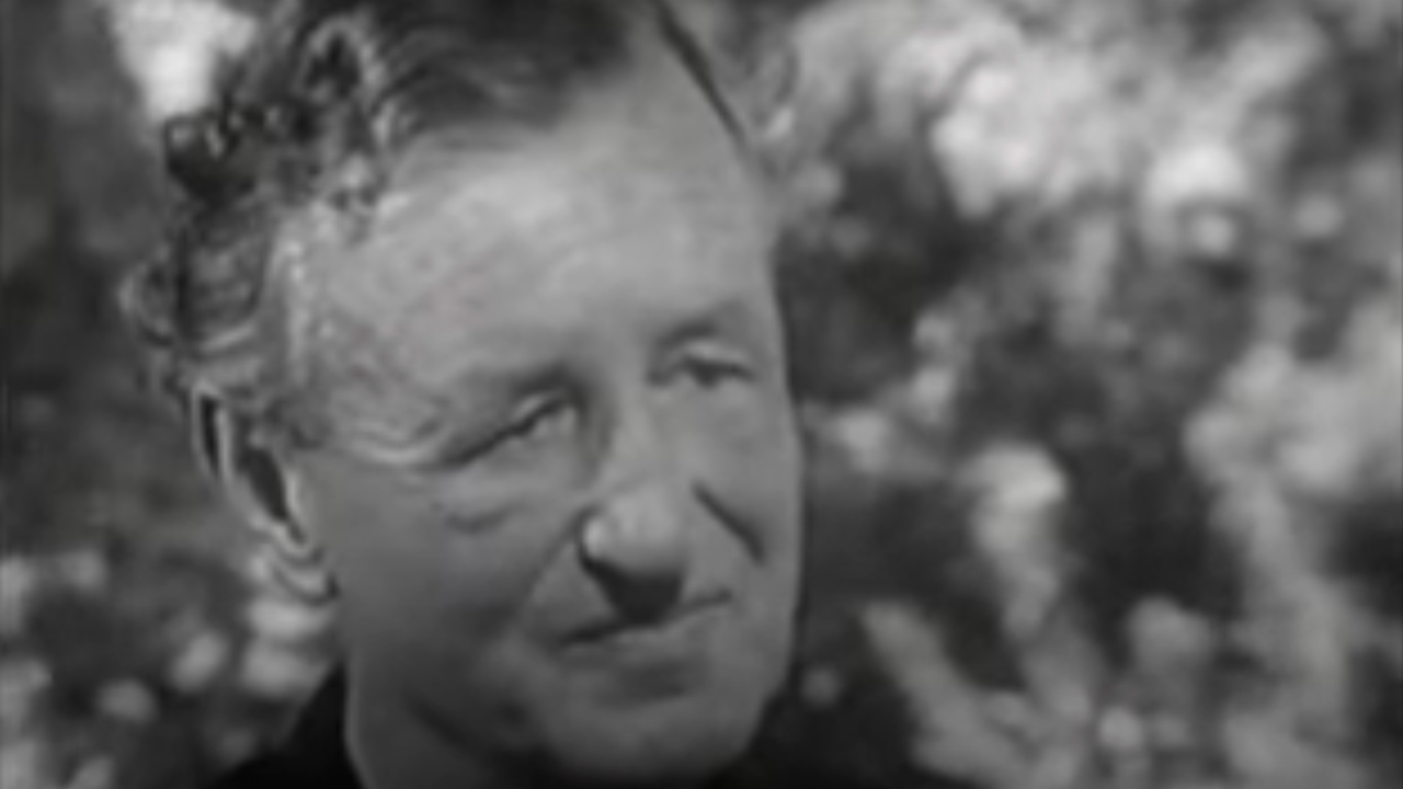 Ian Fleming sits during a CBC interview.