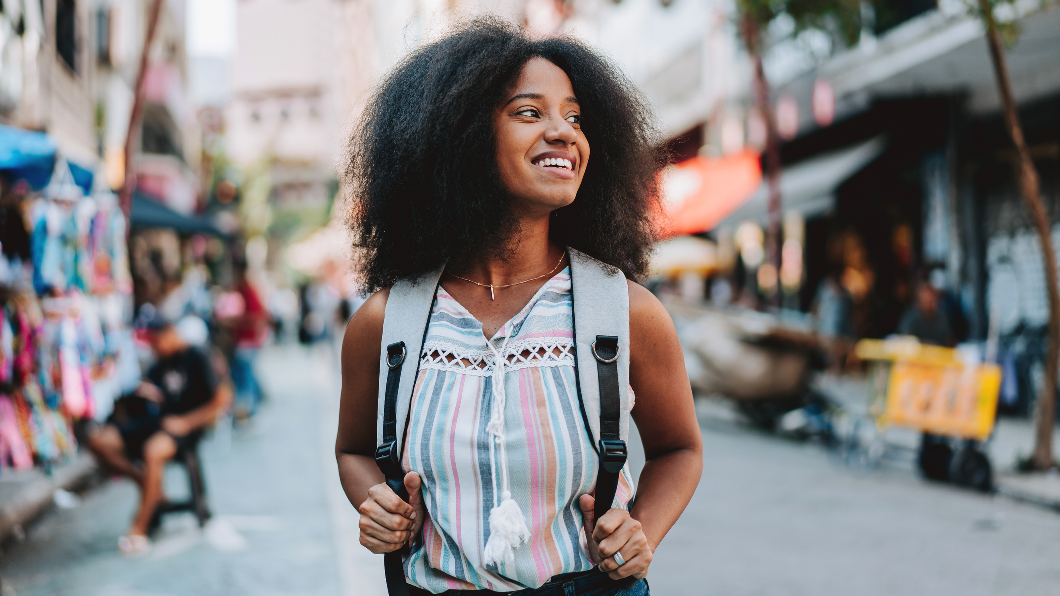 Smiling woman walking through city street