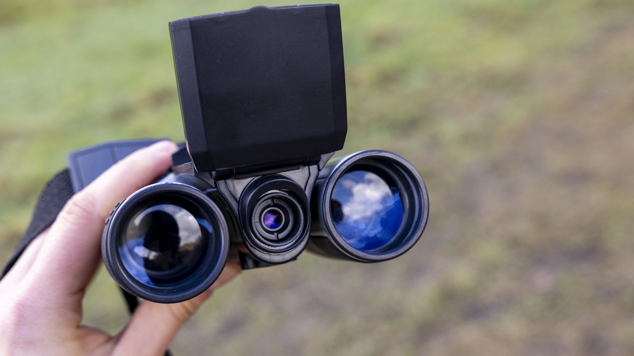 Camonity 12 x 32 digital binoculars in a ladies hand