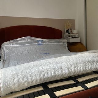DUSK Cool Gel Foam Hybrid mattress in Annie's bedroom on her bed frame, rolled inside plastic vacuum seal wrap